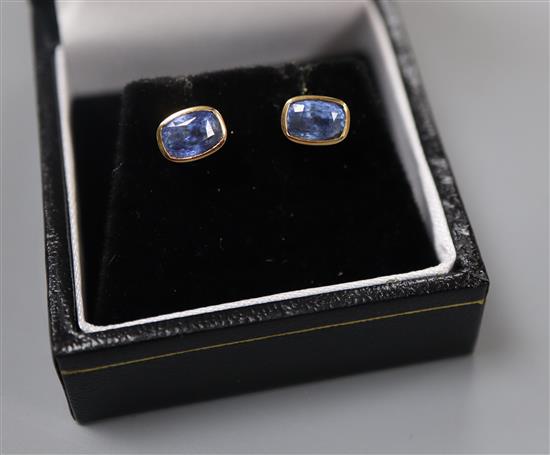 A pair of 750 yellow metal and shaped oval cut sapphire set ear studs, approx. 7mm.